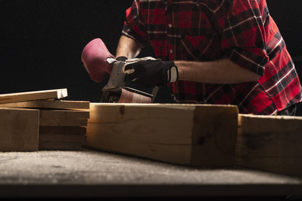 Carpenter works with electrical planer  - Photo, Image
