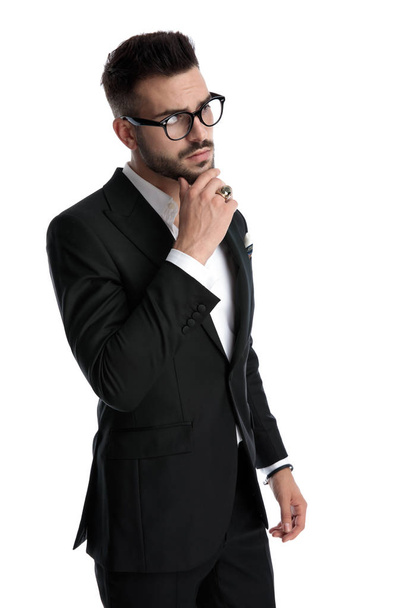 businessman standing and touching chin pensive - Fotoğraf, Görsel