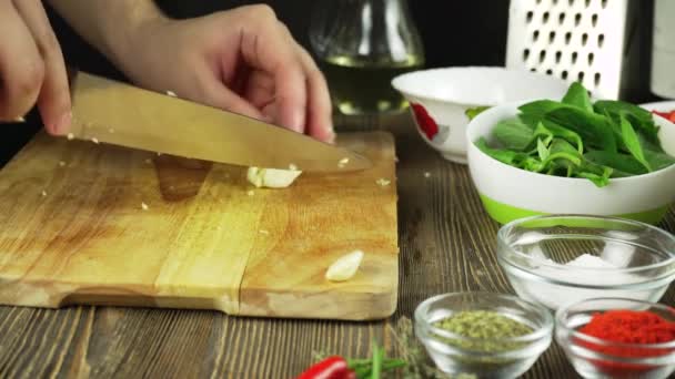 ο σεφ τεμαχίζει το σκόρδο μαχαίρι κοπής του σκάφους σκόρδο γρήγορη κοπή λαχανικών σκόρδο για το τηγάνισμα των χεριών του μάγειρα  - Πλάνα, βίντεο