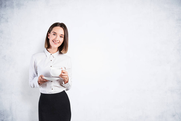 Smiling businesswoman with coffee cup, mock up - Фото, изображение