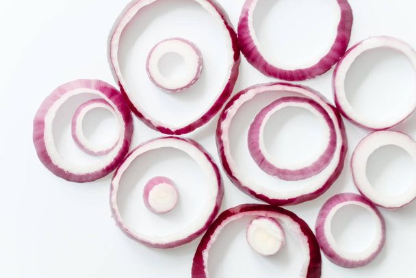 Sliced red onion rings isolated on white background cutout view - Foto, Imagen