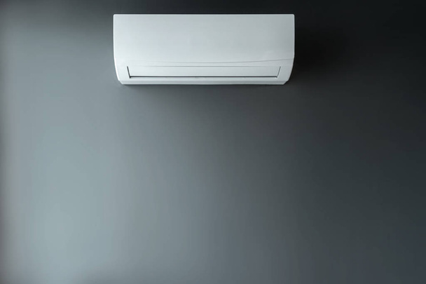 White air conditioning on a gray wall background. The concept of heat, cool air, cooling, freshness. - Fotó, kép