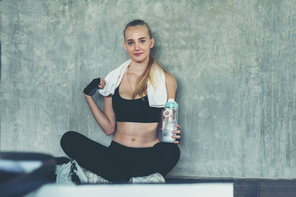 Healthy lifestyle woman drink protein at fitness gym.  Young people girl workout exercise body for diet and slim health.  Fitness instructor exercising the fitness. Diet and Healthy sport Concept - Foto, Bild