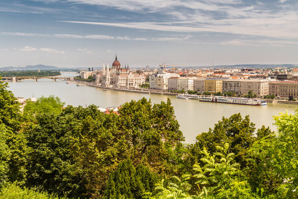 River Danube in Budapest Hungary, parliament building and trees. - Fotó, kép