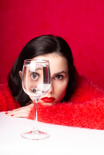 beautiful girl in red with a glass of water - Φωτογραφία, εικόνα