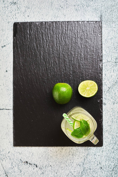 Lemonade with lemons on a slate board - Fotó, kép