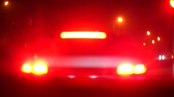 The bokeh effect of the taillights of the car at night.  - Footage, Video