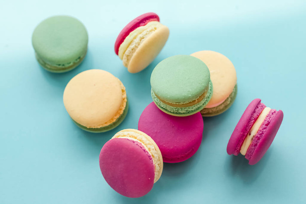 French macaroons on blue background, parisian chic cafe dessert, - 写真・画像