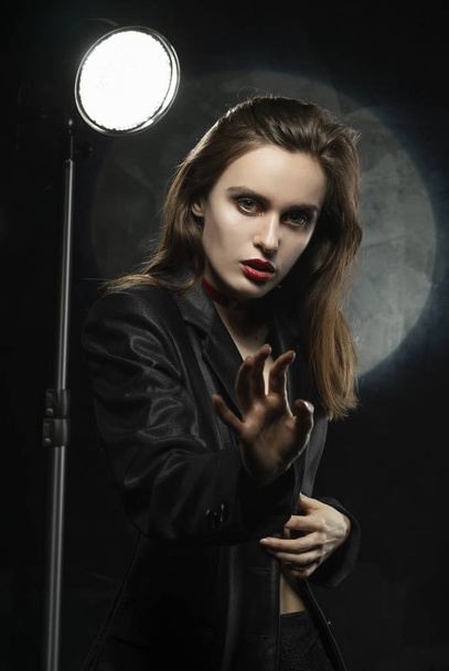 Beautiful slim girl model with red lips, wearing a black blazer, - Fotoğraf, Görsel