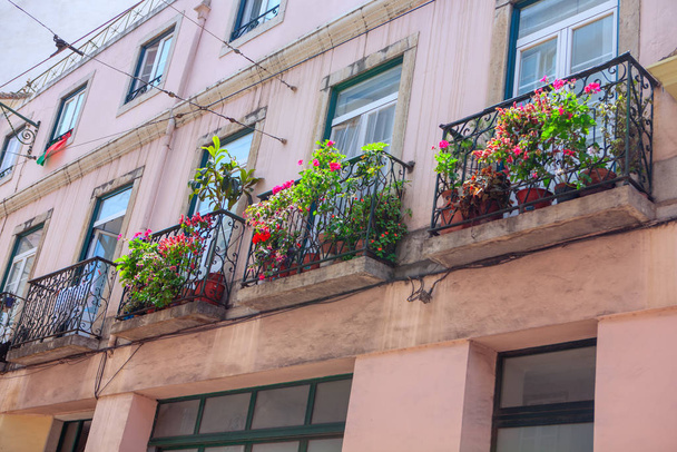 balcony with flowers view from the street  - 写真・画像