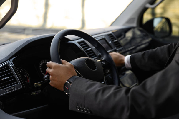 Professional driver in luxury car, closeup. Chauffeur service - Foto, Bild