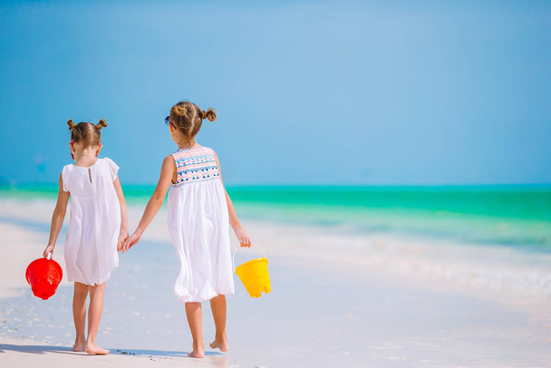 Adorable little girls have fun together on white tropical beach - Photo, Image