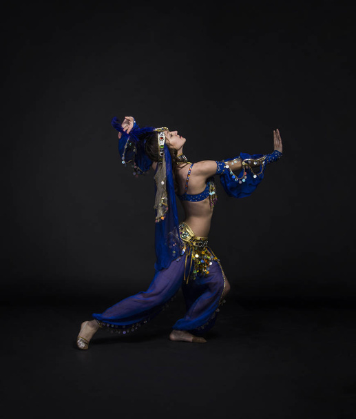 Young,smiling girl dancing the Eastern dance.Belly dance stage performance. - Φωτογραφία, εικόνα
