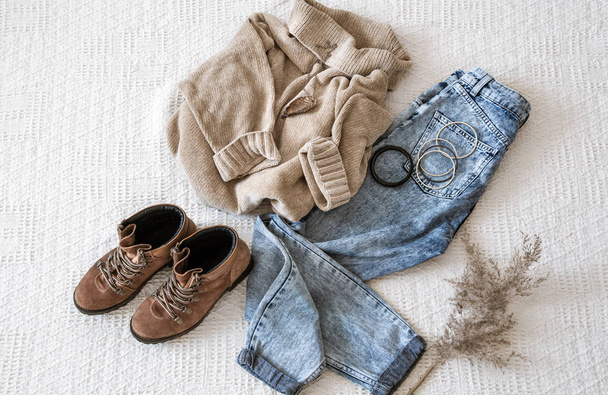 Set with fashionable women's clothing jeans and a sweater . - Foto, imagen