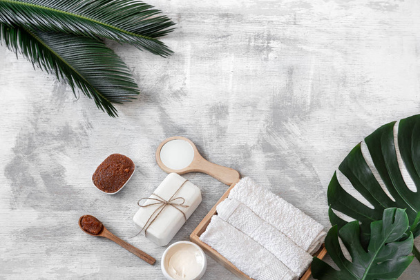 Spa. Body care items on a white background with tropical leaves. - Φωτογραφία, εικόνα
