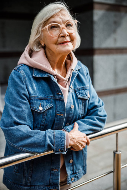 Carefree old woman in stylish clothes stock photo - Zdjęcie, obraz