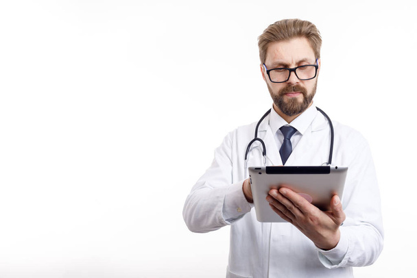 Fiksu ruskea parrakas lääkäri laseissa tabletin avulla
 - Valokuva, kuva