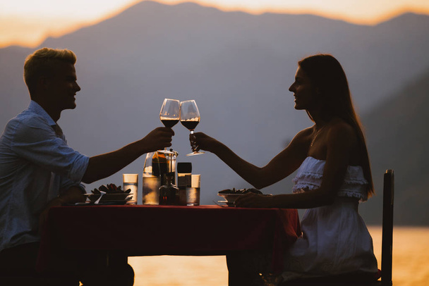 Young romantic couple toasting during dinner on tropical resort - Foto, imagen