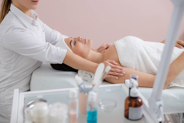 Beautiful young woman having massage at spa salon - Photo, image