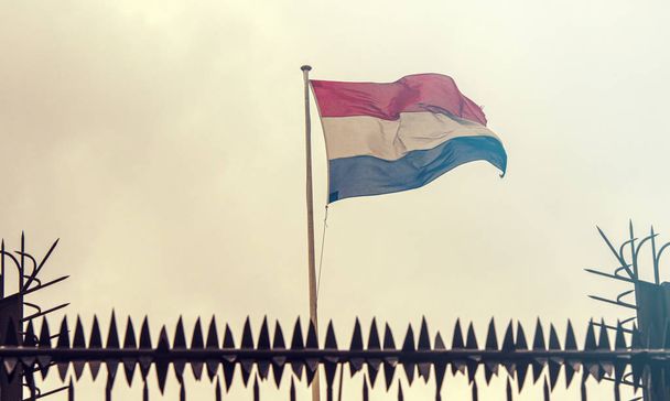 Netherlands Border, Netherlands Flag next to Embassy Fence, toned Picture - Foto, afbeelding