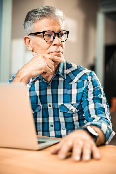 Adult man in glasses looking away indoors - Фото, зображення