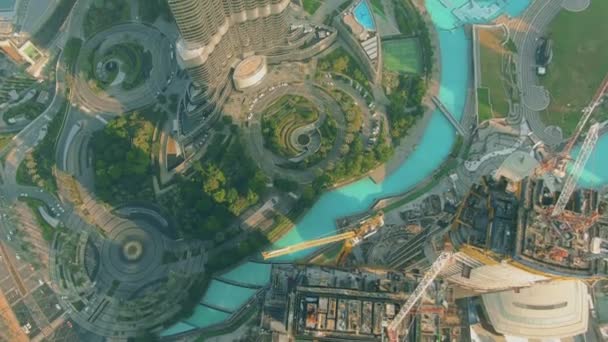 Aerial top down view of Dubai downtown park and skyscraper construction site, UAE - Felvétel, videó