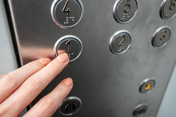 Female hand, finger presses the elevator button. up the career ladder. - Foto, Imagem