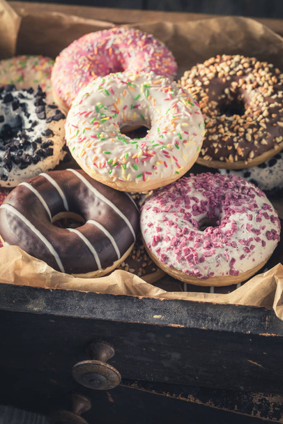 Sweet donuts in old wooden boxes with baking paper - Foto, Imagen