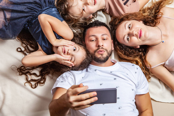 Happy family taking selfie picture with smartphone - Fotó, kép