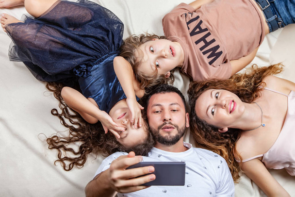 Happy family taking selfie picture with smartphone - 写真・画像