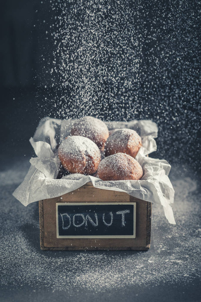Falling sugar on sweet donuts balls hot and freshly baked - Fotografie, Obrázek