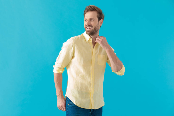Cheerful casual man laughing and adjusting his collar - Photo, Image