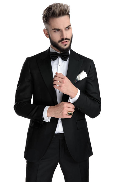 businessman standing and fixing sleeve cool - Foto, Bild