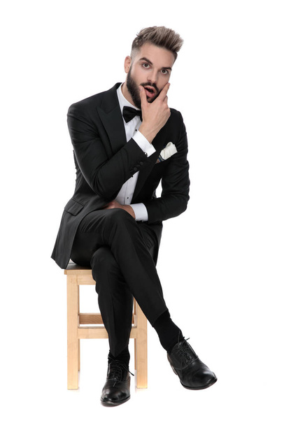 businessman sitting and rubbing his face shocked - Photo, Image