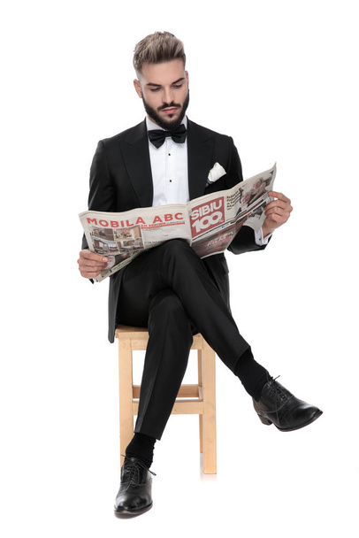 businessman sitting and reading the newspaper serious - 写真・画像