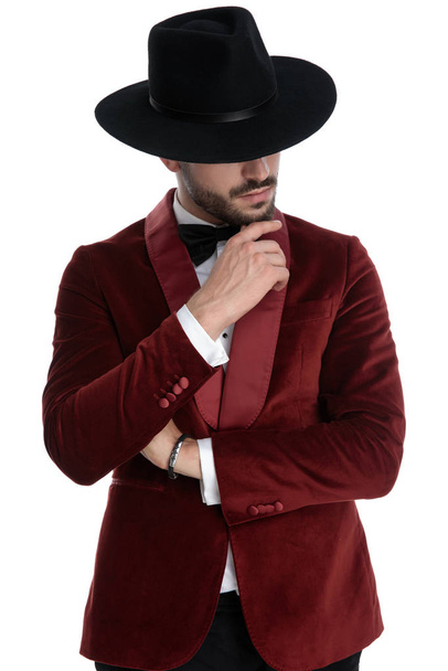 thoughtful fashion model in red velvet tuxedo thinking - Photo, Image