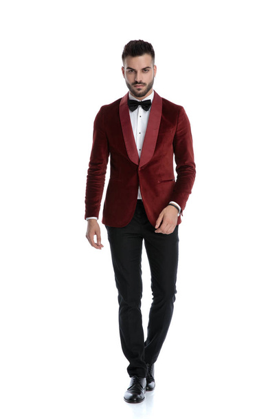 cool fashion man in red velvet tuxedo walking - Фото, зображення
