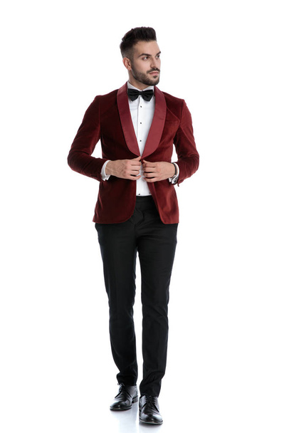 sexy young model in red velvet tuxedo adjusting coat - Zdjęcie, obraz