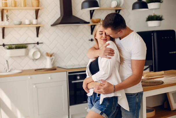 Beautiful couple spend time in a kitchen - Foto, afbeelding