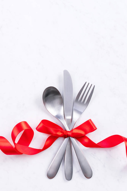 Valentine's Day, Mother's Day, holiday dating meal, banquet design concept - White plate and red ribbon on marble background, top view, flat lay. - Zdjęcie, obraz