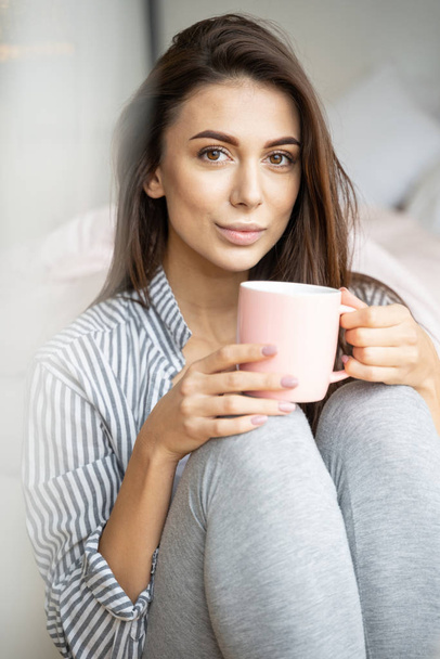 Girl with a hot drink relaxing at home - Valokuva, kuva