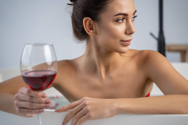 Young woman with a glass of beverage - Fotoğraf, Görsel