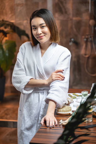 Attractive Asian woman wearing white bathrobe in beauty salon - Fotoğraf, Görsel