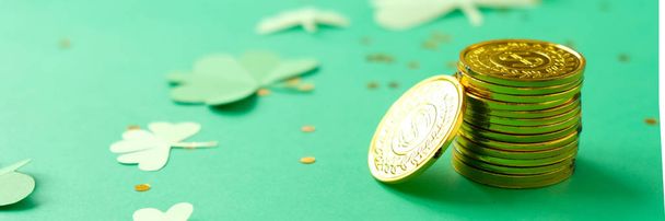 St. Patrick's day, clover and gold coins on a green background - Фото, изображение