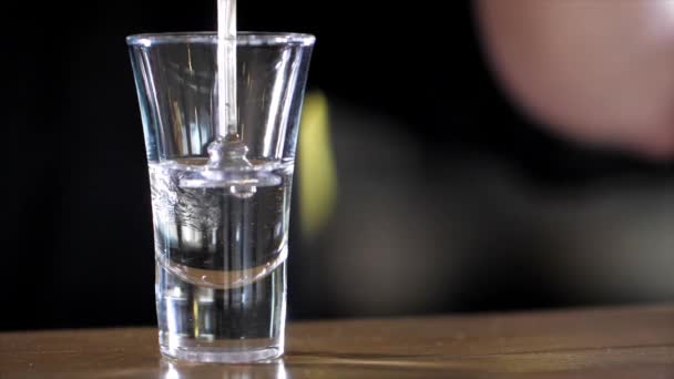 Barman is making alcohol cocktail with three layers - Video
