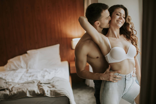 Young couple standing in the room of the apartment - Photo, Image