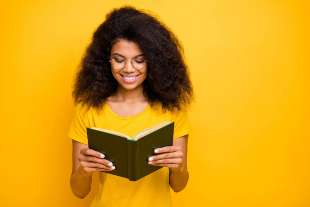 Close-up portrait of her she nice attractive lovely brainy cheerful cheery wavy-haired girl reading novel visit library isolated over bright vivid shine vibrant yellow color background - Foto, immagini