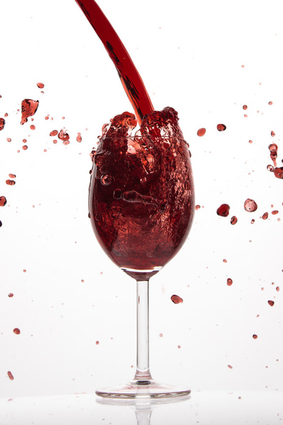 pouring red wine - Фото, изображение