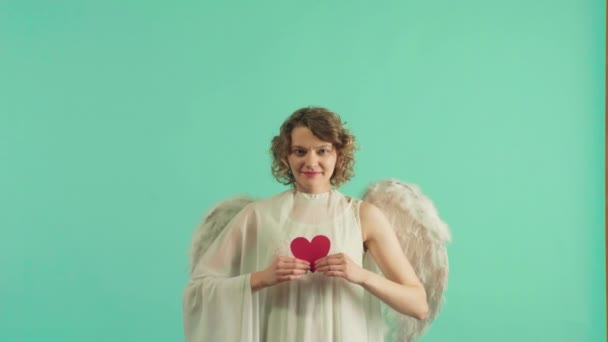 Pretty girl as the cupid with a wings congratulating on St Valentines day. Angel children girl with white wings. - Footage, Video
