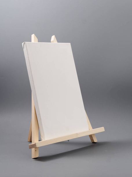 easel made of wood table on a gray background - Fotoğraf, Görsel